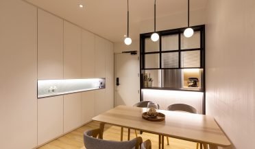 minimalist dining area featuring sleek cabinets and clean lines