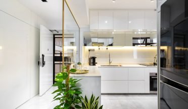 modern kitchen with a white countertop and a black fridge