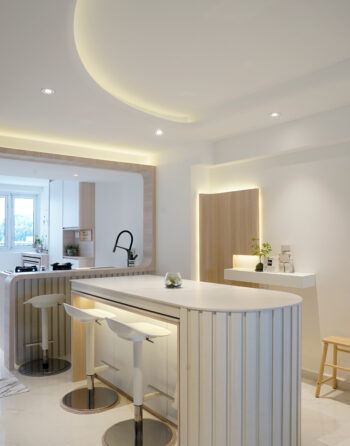 Modern minimalist kitchen with island and soft ambient lighting.